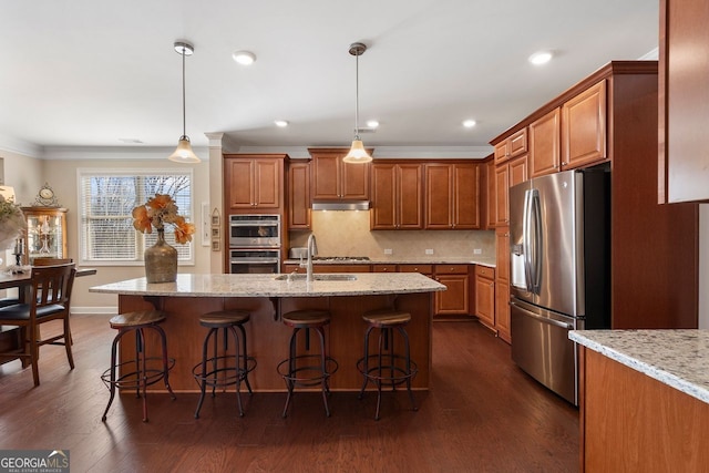 4538 Sterling Pointe Dr NW, Kennesaw, GA 30152 - kitchen with appliances with stainless steel finishes, under cabinet range hood, a sink, crown molding, and brown cabinetry
