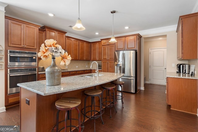 4538 Sterling Pointe Dr NW, Kennesaw, GA 30152 - kitchen featuring stainless steel appliances, a sink, brown cabinets, tasteful backsplash, and dark wood-style floors