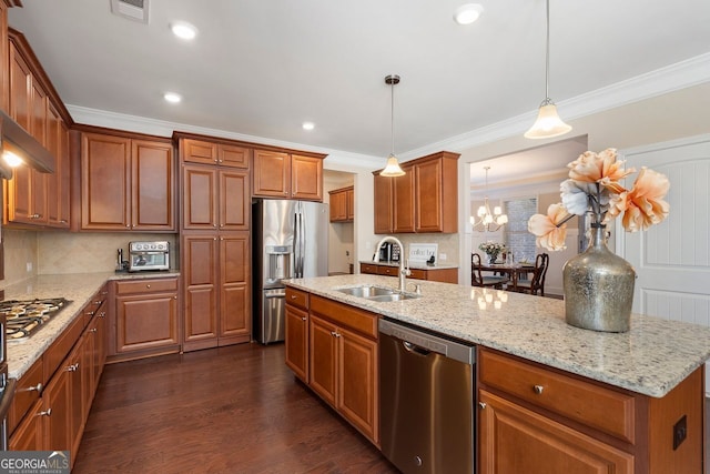 4538 Sterling Pointe Dr NW, Kennesaw, GA 30152 - kitchen featuring appliances with stainless steel finishes, a sink, brown cabinetry, light stone counters, and ornamental molding