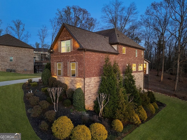 4538 Sterling Pointe Dr NW, Kennesaw, GA 30152 - view of side of property with stone siding, a lawn, roof with shingles, and brick siding