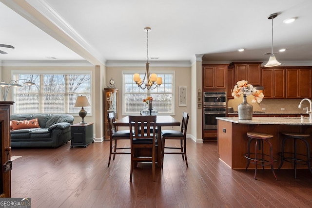 4538 Sterling Pointe Dr NW, Kennesaw, GA 30152 - dining space featuring crown molding, a chandelier, healthy amount of natural light, baseboards, and dark wood-style floors