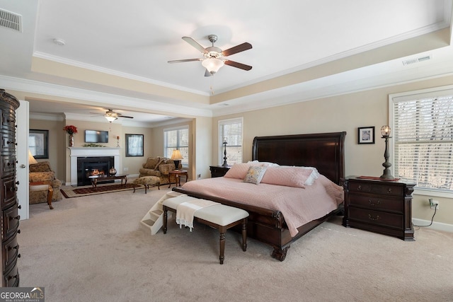 4538 Sterling Pointe Dr NW, Kennesaw, GA 30152 - bedroom featuring carpet floors, a tray ceiling, ornamental molding, a warm lit fireplace, and baseboards