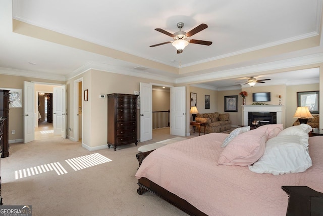 4538 Sterling Pointe Dr NW, Kennesaw, GA 30152 - bedroom with a raised ceiling, crown molding, baseboards, light carpet, and a fireplace