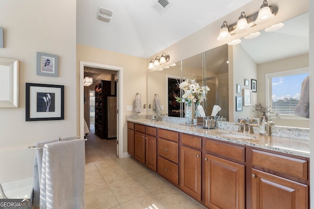 4538 Sterling Pointe Dr NW, Kennesaw, GA 30152 - full bath featuring vaulted ceiling, tile patterned flooring, double vanity, and a shower with door