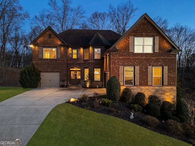 4538 Sterling Pointe Dr NW, Kennesaw, GA 30152 - view of front of home with concrete driveway, an attached garage, a front lawn, brick siding, and stone siding