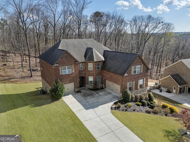 4538 Sterling Pointe Dr NW, Kennesaw, GA 30152 - view of front facade featuring brick siding, an attached garage, concrete driveway, and a front lawn