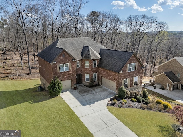 4538 Sterling Pointe Dr NW, Kennesaw, GA 30152 - view of front facade featuring brick siding, an attached garage, concrete driveway, and a front lawn