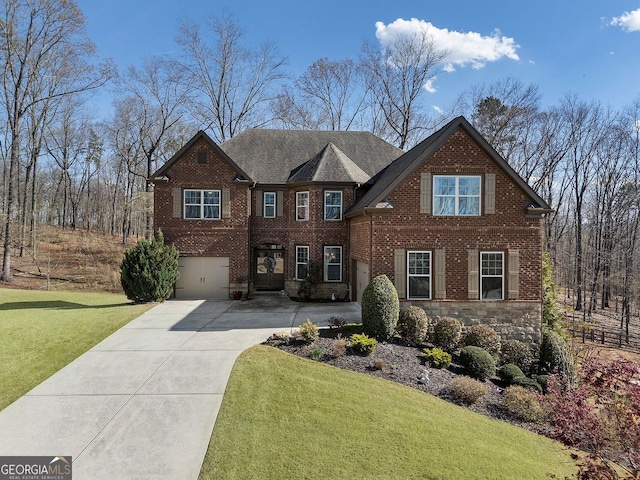 4538 Sterling Pointe Dr NW, Kennesaw, GA 30152 - view of front of home with concrete driveway, a front yard, an attached garage, and brick siding