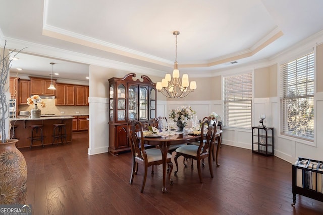 4538 Sterling Pointe Dr NW, Kennesaw, GA 30152 - dining space with a raised ceiling, a chandelier, dark wood finished floors, a decorative wall, and a wainscoted wall
