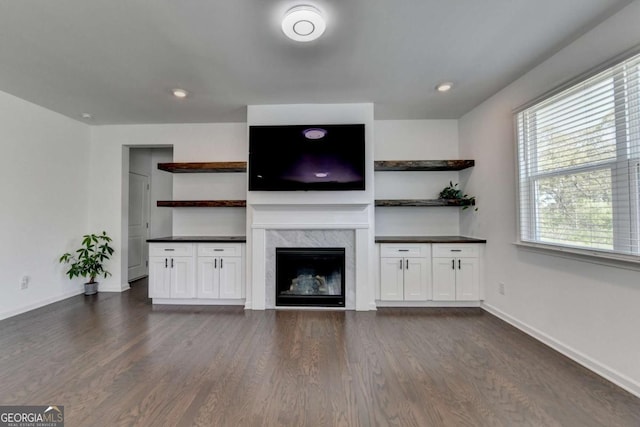 5530 Bower Pl, Cumming, GA 30028 - unfurnished living room with a premium fireplace, baseboards, and dark wood finished floors