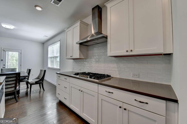 5530 Bower Pl, Cumming, GA 30028 - kitchen with visible vents, wall chimney range hood, dark countertops, dark wood-style floors, and stainless steel gas cooktop