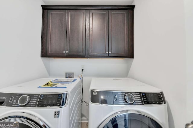 5530 Bower Pl, Cumming, GA 30028 - laundry area with cabinet space and washer and clothes dryer