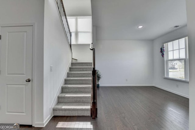 5530 Bower Pl, Cumming, GA 30028 - stairway featuring visible vents, baseboards, and wood finished floors