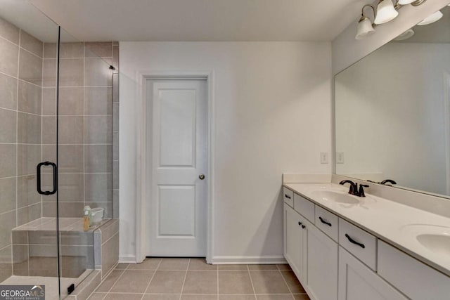 5530 Bower Pl, Cumming, GA 30028 - bathroom with a shower stall, tile patterned floors, double vanity, and a sink