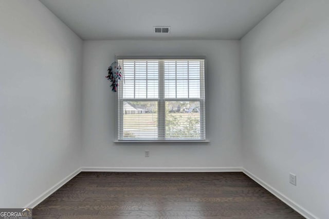 5530 Bower Pl, Cumming, GA 30028 - unfurnished room with visible vents, baseboards, plenty of natural light, and dark wood finished floors