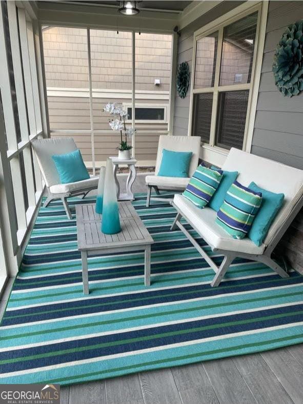 sunroom / solarium with ceiling fan