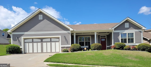craftsman-style house featuring driveway, a garage, stone siding, and a front lawn