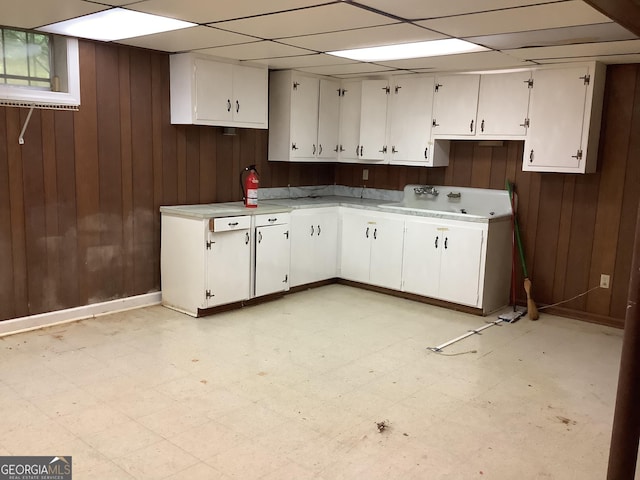 10 Horseshoe Bend Rd SW, Rome, GA 30165 - kitchen with light floors, light countertops, wooden walls, and white cabinets