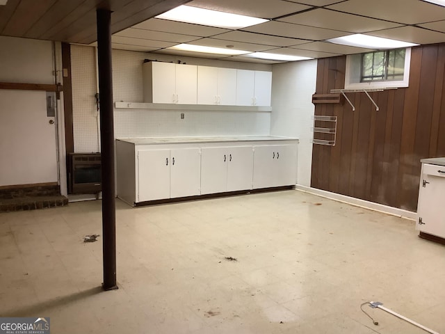 10 Horseshoe Bend Rd SW, Rome, GA 30165 - below grade area with baseboards, light floors, wooden walls, and heating unit