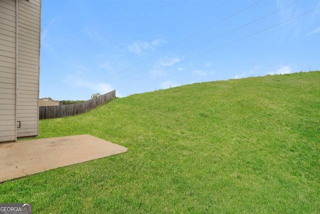 view of yard with fence and a patio
