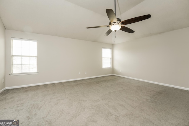 unfurnished room with carpet flooring, baseboards, and a ceiling fan