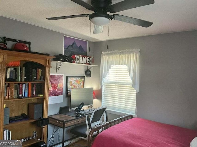 bedroom featuring a textured ceiling and ceiling fan