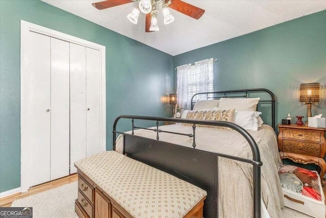 bedroom with a closet, a ceiling fan, and light wood-type flooring