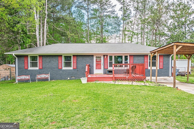 ranch-style home featuring concrete driveway, a carport, a front yard, brick siding, and a shingled roof