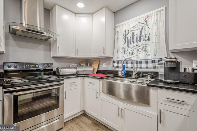 kitchen with stainless steel electric range, range hood, a sink, and white cabinetry