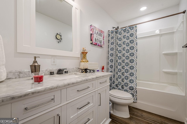 full bathroom featuring vanity, recessed lighting, toilet, wood finished floors, and shower / tub combo