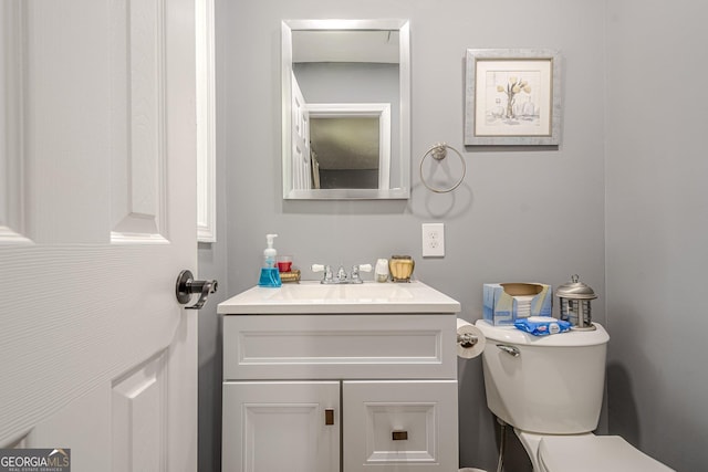 bathroom featuring toilet and vanity