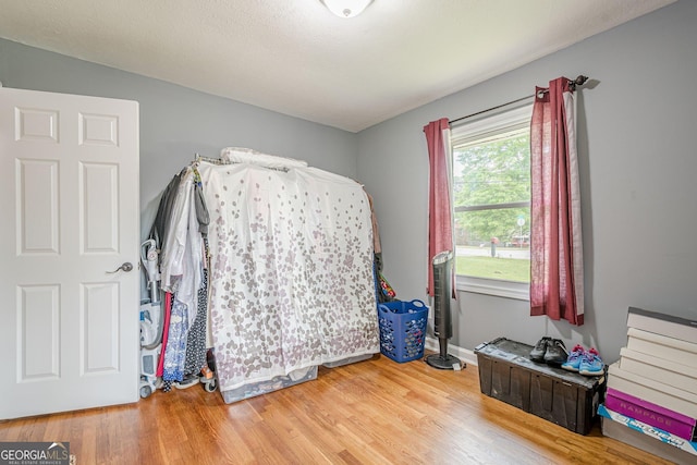 bedroom featuring baseboards and light wood finished floors