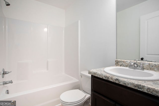 bathroom with toilet, vanity, and shower / tub combination