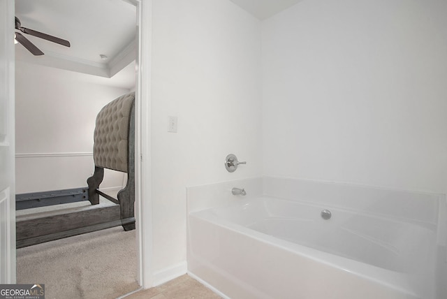 bathroom with a garden tub, baseboards, a ceiling fan, and tile patterned flooring