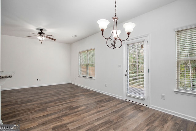 unfurnished dining area featuring dark wood-style flooring, visible vents, baseboards, and a healthy amount of sunlight