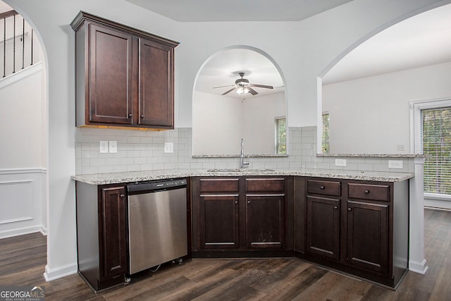 kitchen featuring ceiling fan, stainless steel dishwasher, dark wood-type flooring, tasteful backsplash, and a sink