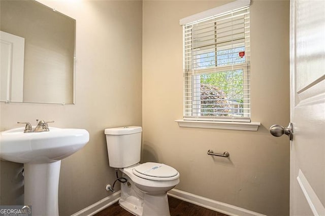 3459 Village Park Ln, Atlanta, GA 30331 - half bathroom with baseboards, a sink, toilet, and wood finished floors