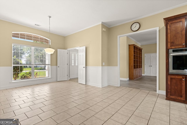 911 Larkspur Ln, Saint Marys, GA 31558 - unfurnished living room featuring light tile patterned floors, visible vents, ornamental molding, and wainscoting