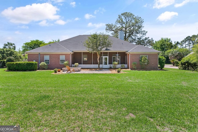 911 Larkspur Ln, Saint Marys, GA 31558 - back of property with brick siding, a sunroom, and a lawn