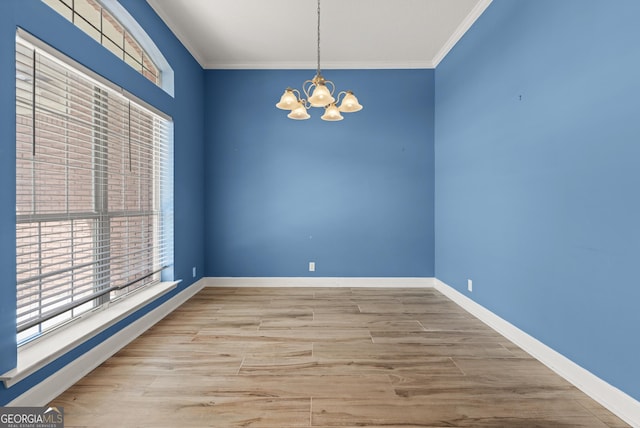 911 Larkspur Ln, Saint Marys, GA 31558 - empty room with a chandelier, plenty of natural light, ornamental molding, and wood finished floors