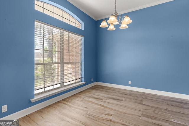 911 Larkspur Ln, Saint Marys, GA 31558 - empty room featuring a chandelier, wood finished floors, baseboards, and ornamental molding