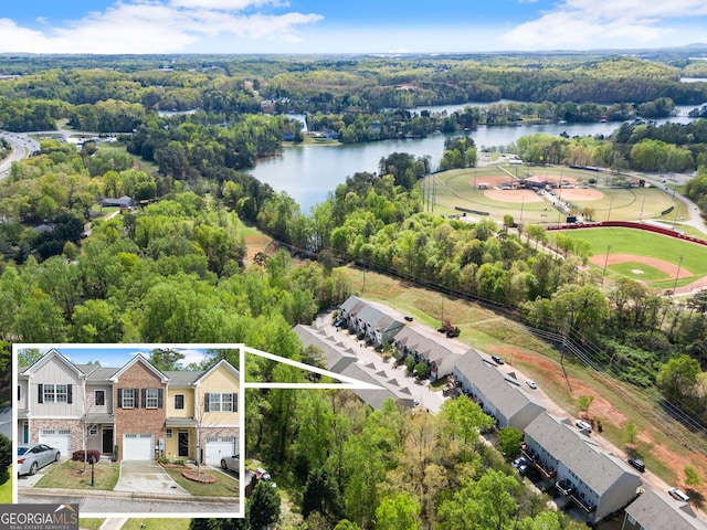 birds eye view of property with a forest view and a water view
