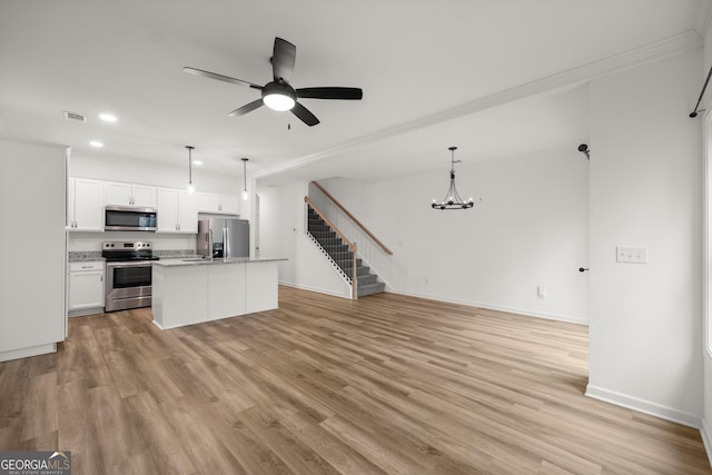 1536 Bluff Valley Cir, Gainesville, GA 30504 - kitchen featuring stainless steel appliances, recessed lighting, open floor plan, a chandelier, and light wood-style flooring