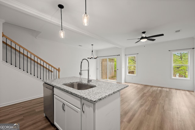 kitchen featuring open floor plan, dishwasher, ceiling fan with notable chandelier, a sink, and wood finished floors