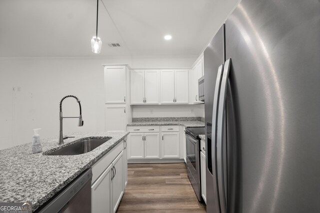 1536 Bluff Valley Cir, Gainesville, GA 30504 - kitchen featuring appliances with stainless steel finishes, a sink, ornamental molding, white cabinets, and light stone counters