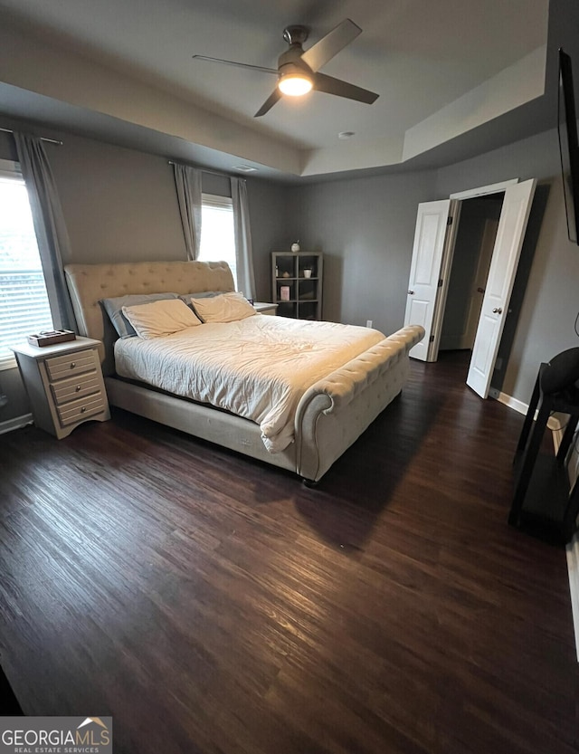 1058 Mays Hl, Atlanta, GA 30336 - bedroom with a ceiling fan, baseboards, a raised ceiling, and dark wood finished floors