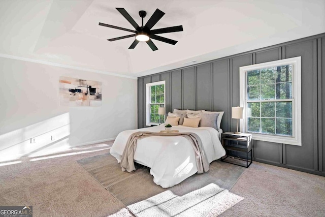 bedroom featuring a decorative wall, carpet flooring, and ceiling fan