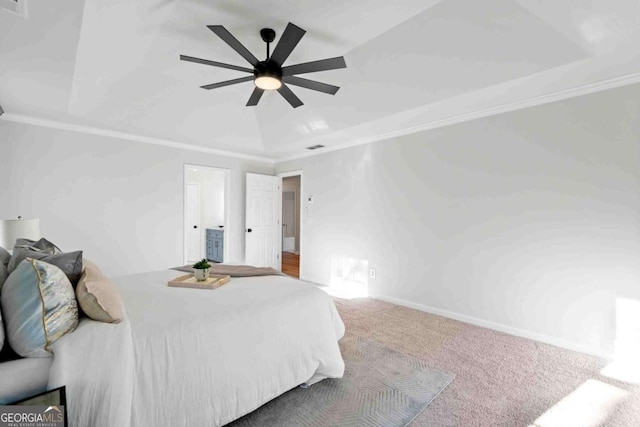 bedroom with a raised ceiling, carpet, and a ceiling fan