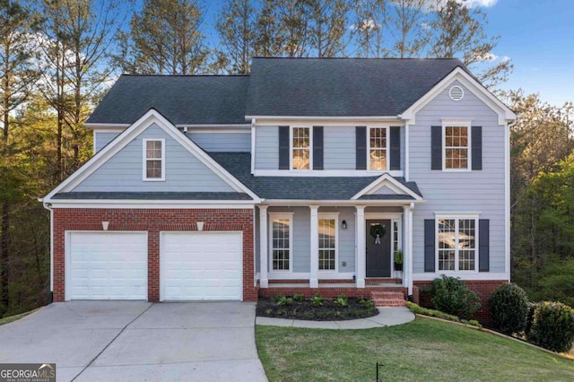 traditional-style home featuring brick siding, a porch, concrete driveway, a front lawn, and roof with shingles