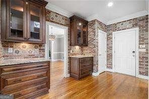 bar featuring brick wall and wood finished floors